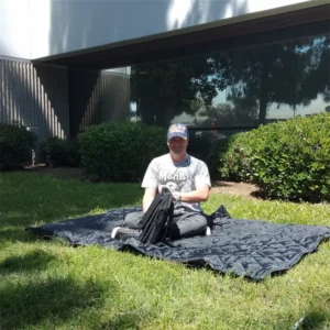Person using black blanket outdoors