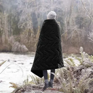 Person wearing black blanket outdoors