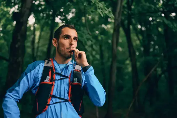 ein Mann, der Wasser aus einem Trinkrucksack trinkt