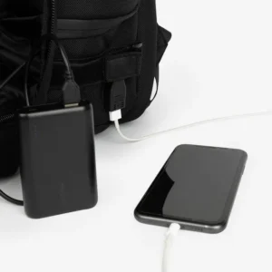 tactical backpack side showing USB port connected to black power bank