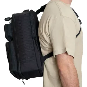 Person wearing a black tactical sling backpack over the shoulder
