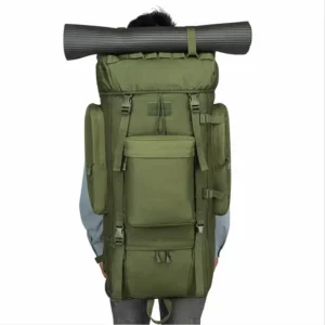 person wearing green tactical military backpack with sleeping mat strapped on top
